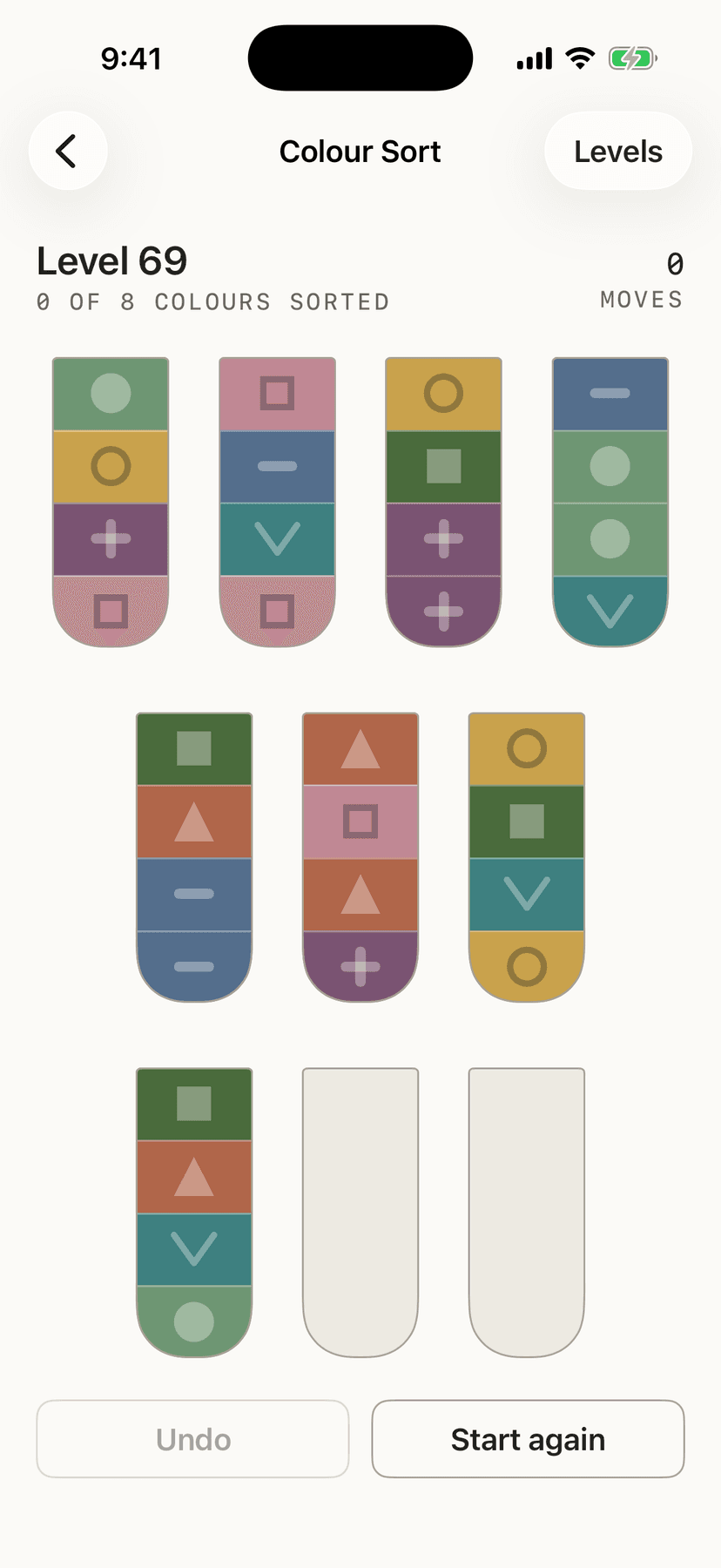 Colour Sort at level sixty-nine: eleven tubes of stacked colors, each band marked with its own shape as well as its color.